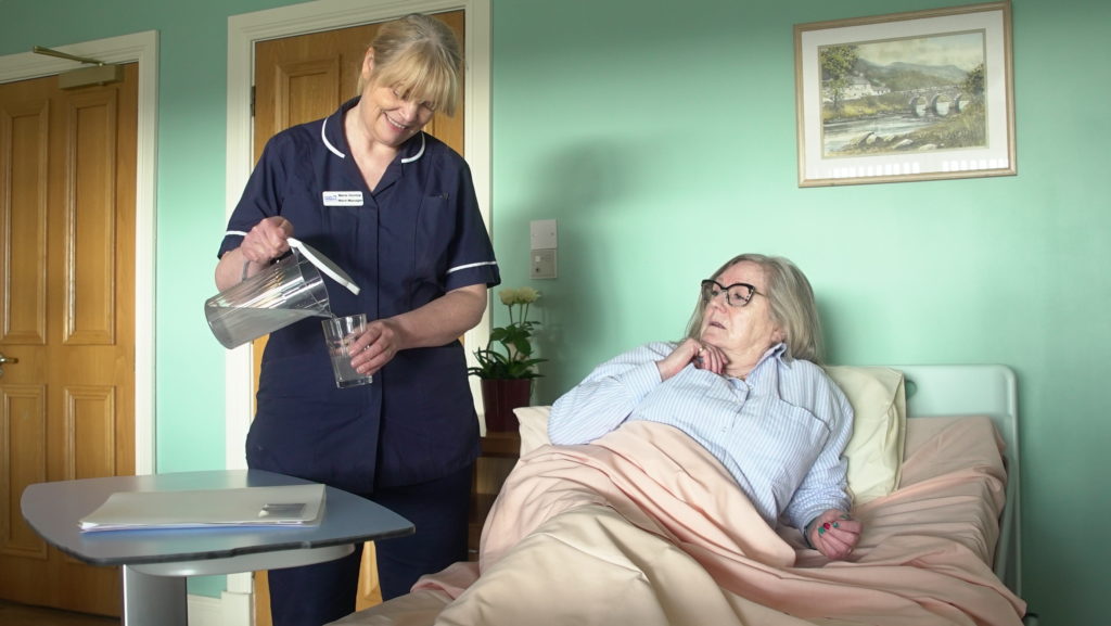 A Foyle Hospice nurse with a patient in our Inpatient Unit